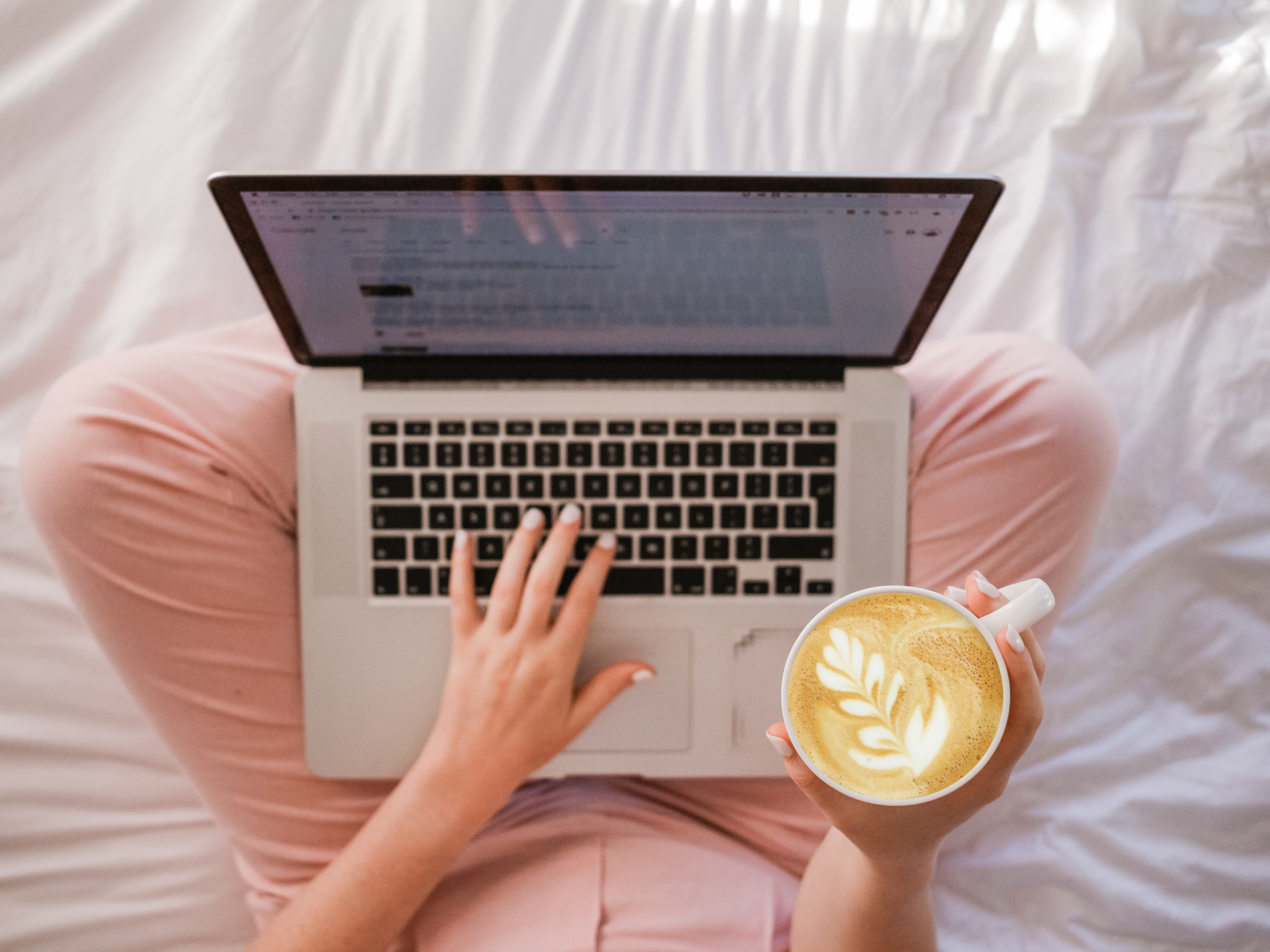 woman on laptop with a coffee